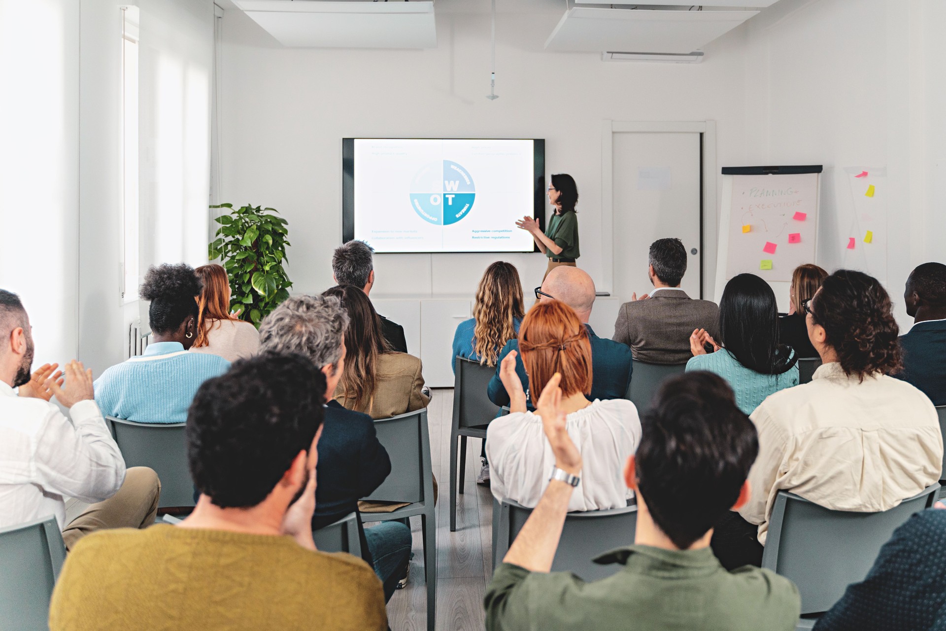 Business Presentation with Diverse Audience Applauding